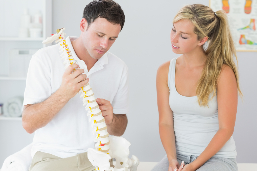 Chiropractor Explaining The Benefits to Woman